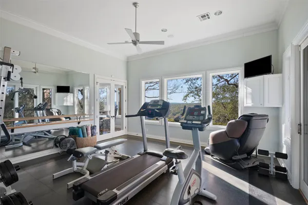 a room with gym equipment and a large window
