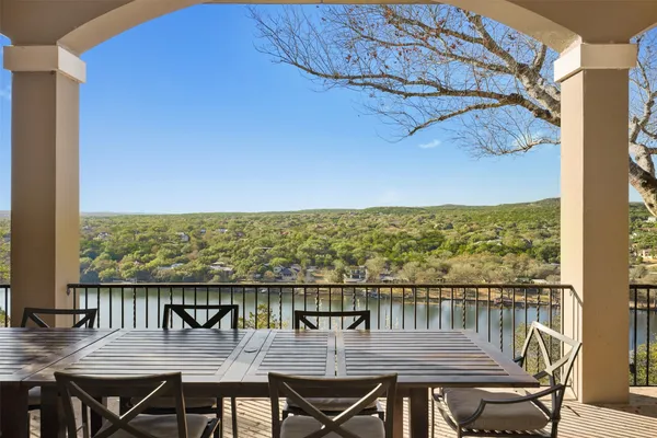 a view of a chairs and table on the roof deck