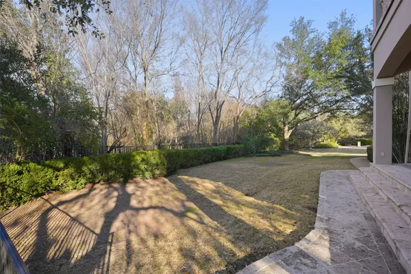 a view of a backyard with large trees