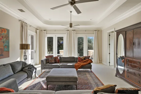 a living room with furniture and large windows