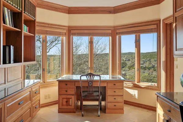 a view of a bedroom with furniture and windows