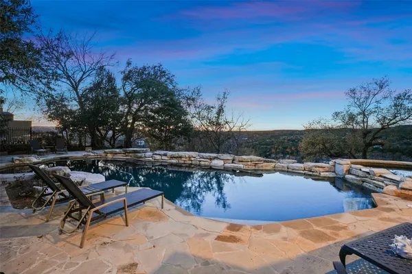 a view of a swimming pool with lounge chairs