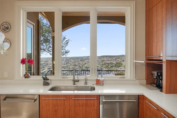a kitchen with stainless steel appliances granite countertop a sink and a window