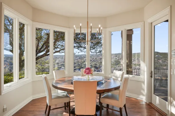 a dining room with furniture window and wooden floor