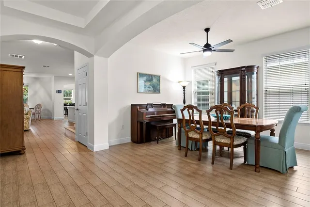 a view of a dining room with furniture and wooden floor