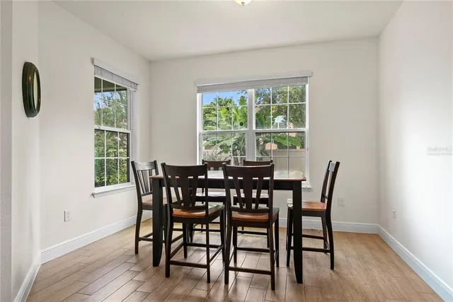 a view of a dining room with furniture and windows
