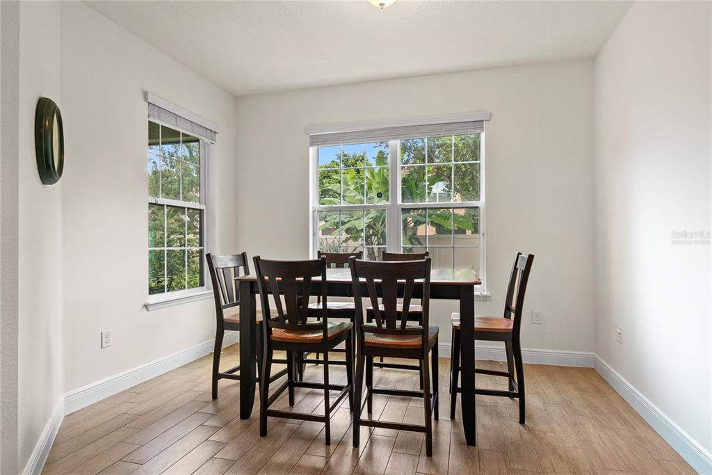 11922 Angle Pond Avenue Windermere, FL 34786 - Photo 14 of 45 a view of a dining room with furniture and windows