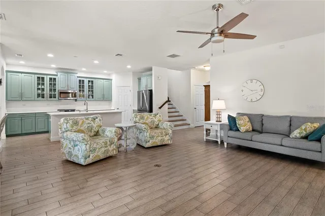 a living room with furniture and kitchen view