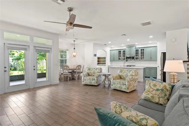 a living room with furniture and a chandelier