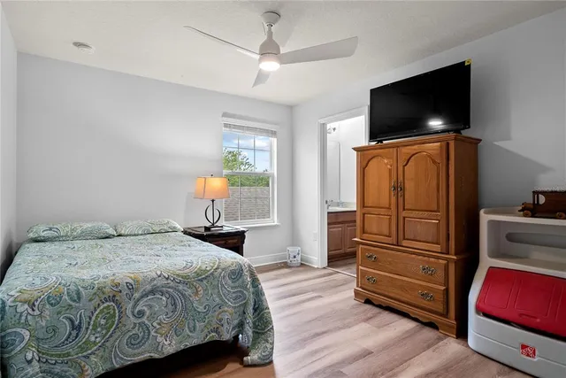 a bedroom with a bed and flat screen tv