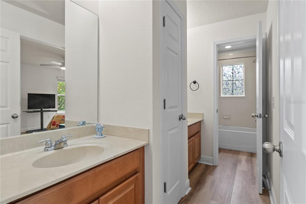 11922 Angle Pond Avenue Windermere, FL 34786 - Photo 24 of 45 a en suite bathroom with a granite countertop sink and a mirror