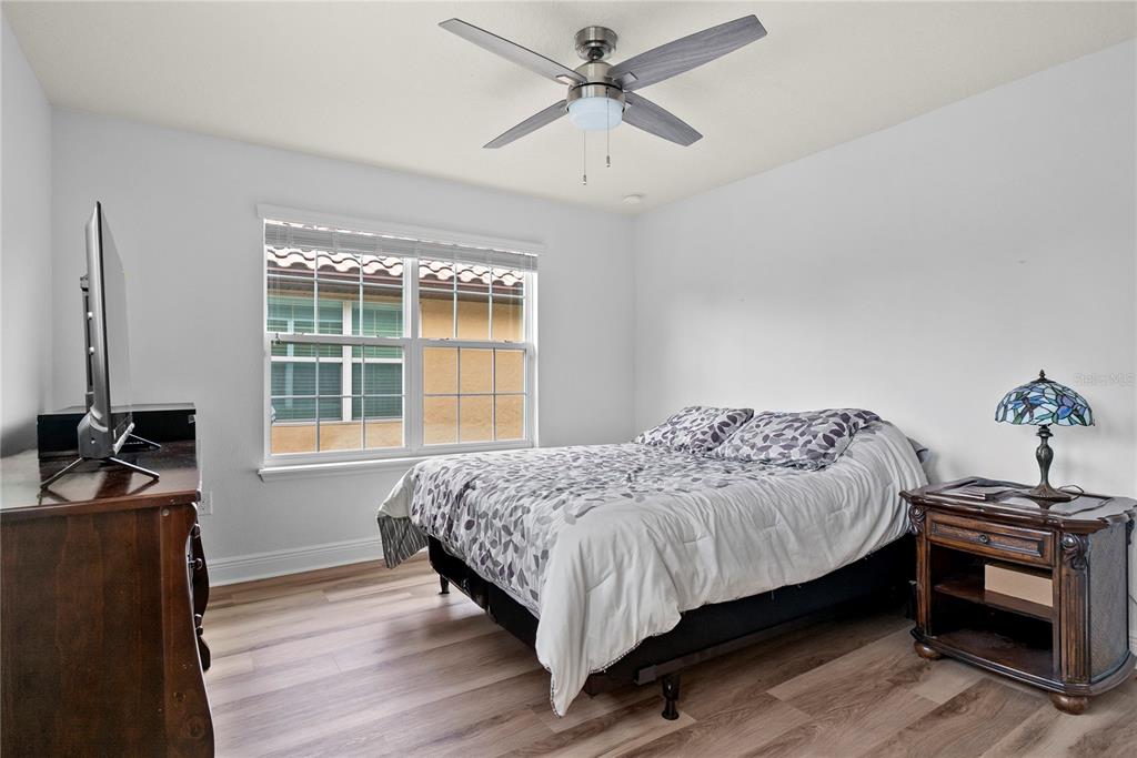 11922 Angle Pond Avenue Windermere, FL 34786 - Photo 25 of 45 a bedroom with a bed and a window