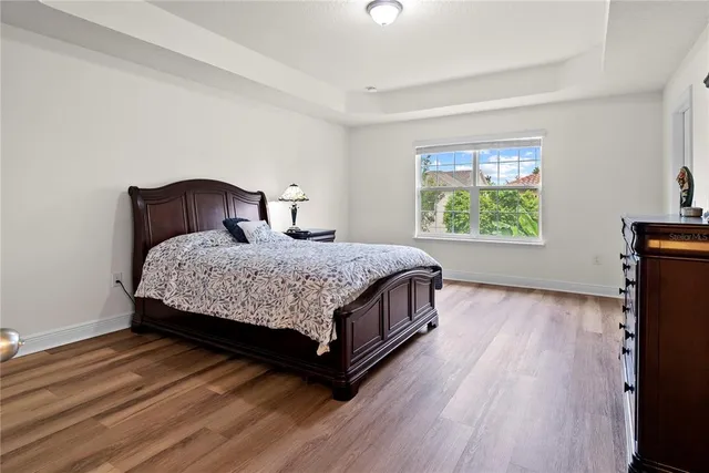 a bedroom with a bed lamp closet and window