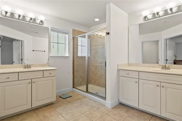 a bathroom with a shower sink and mirror