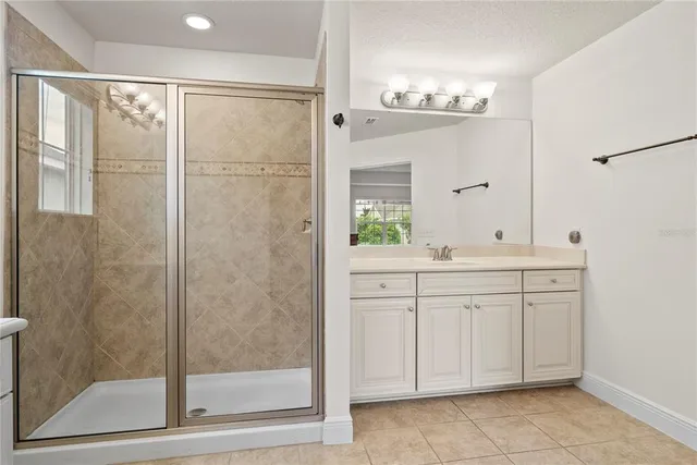 a bathroom with a shower sink and mirror