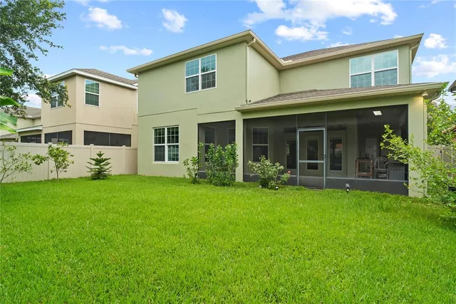 a view of a house with backyard and a garden