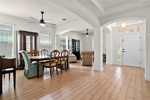 a view of a dining room with furniture and wooden floor