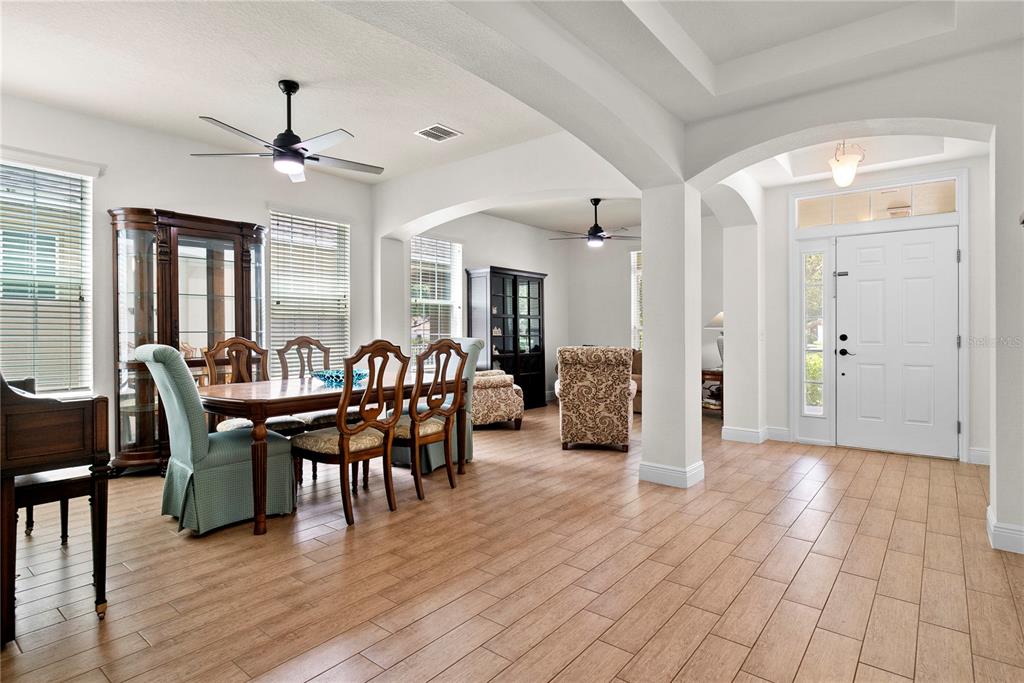 11922 Angle Pond Avenue Windermere, FL 34786 - Photo 10 of 45 a view of a dining room with furniture and wooden floor