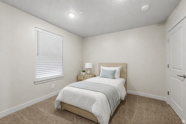 6231 Winding Way, Unit K105 Hurricane, UT 84737 - Photo 15 of 20 Carpeted bedroom with baseboards