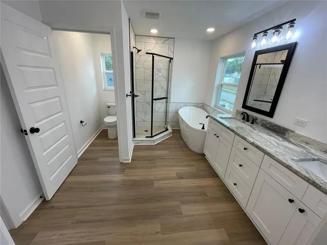 a bathroom with a double vanity sink and mirror