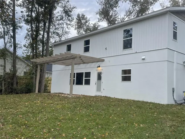 a house that has a tree in front of it