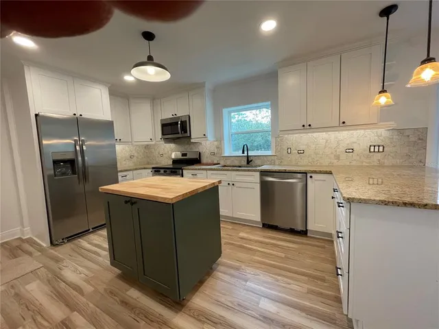 a kitchen with a sink stove and refrigerator