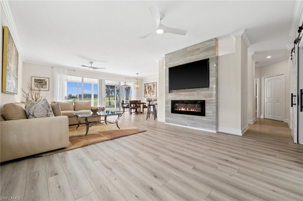 13180 Hamilton Harbour Drive, Unit E1 Naples, FL 34110 - Photo 1 of 30 Beautifully Updated with a Modern Flare – Relax and Enjoy Golf Course Views! Cozy electric fireplace.