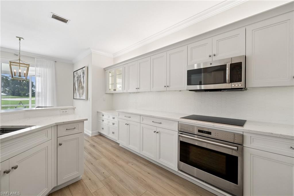13180 Hamilton Harbour Drive, Unit E1 Naples, FL 34110 - Photo 14 of 30 Updated modern Kitchen with and abundance of cabinet space.