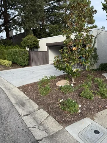 a sign that is sitting in front of flowers