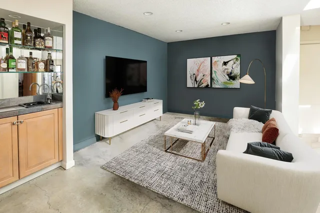 a living room with furniture and a flat screen tv