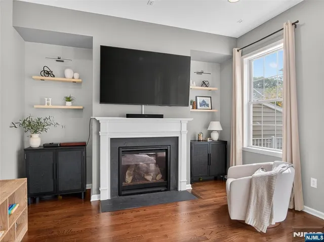 a living room with furniture fireplace and flat screen tv