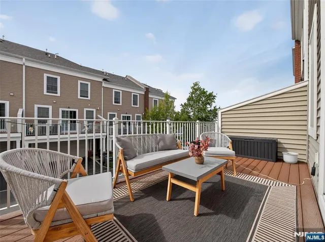 a living room with furniture and a dining table with wooden floor