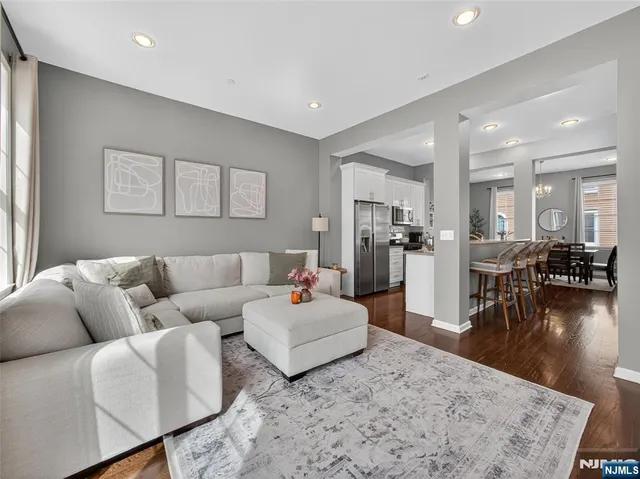 a kitchen with stainless steel appliances granite countertop a table and chairs