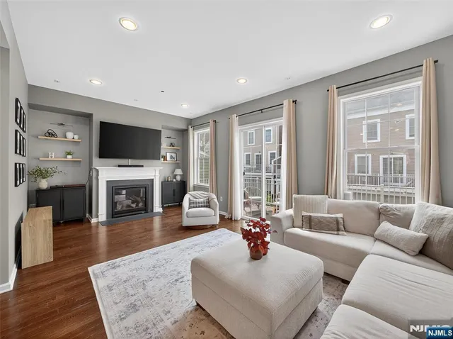 a living room with fireplace furniture and a flat screen tv
