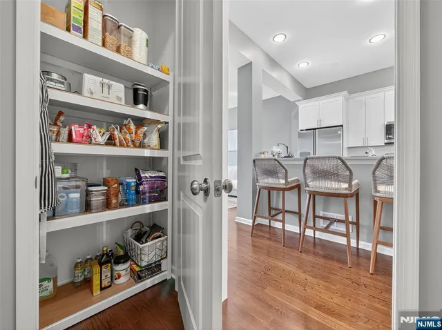 a kitchen with stainless steel appliances granite countertop white cabinets and stove