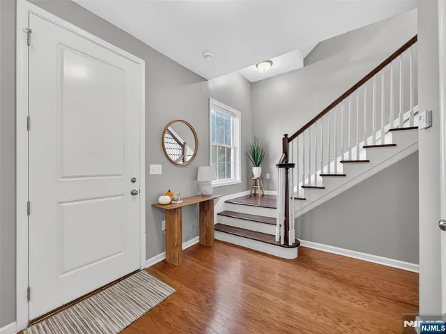 a view of entryway with wooden floor and stairs