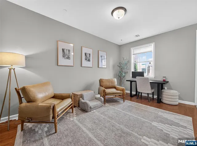 a living room with furniture and a lamp