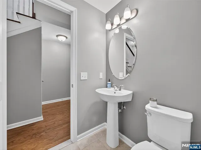a view of entryway livingroom and hall with wooden floor