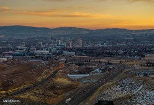 a view of a town with mountains in the background