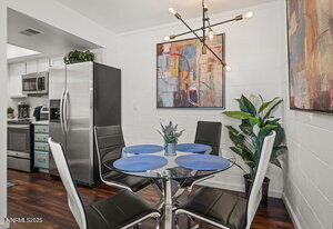 3905 Covington Way, Unit A Reno, NV 89503 - Photo 5 of 28 a view of a dining room with furniture a potted plant and wooden floor