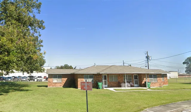 a front view of a building with garden