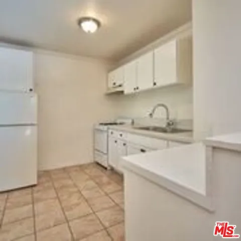 a kitchen with a sink cabinets and appliances