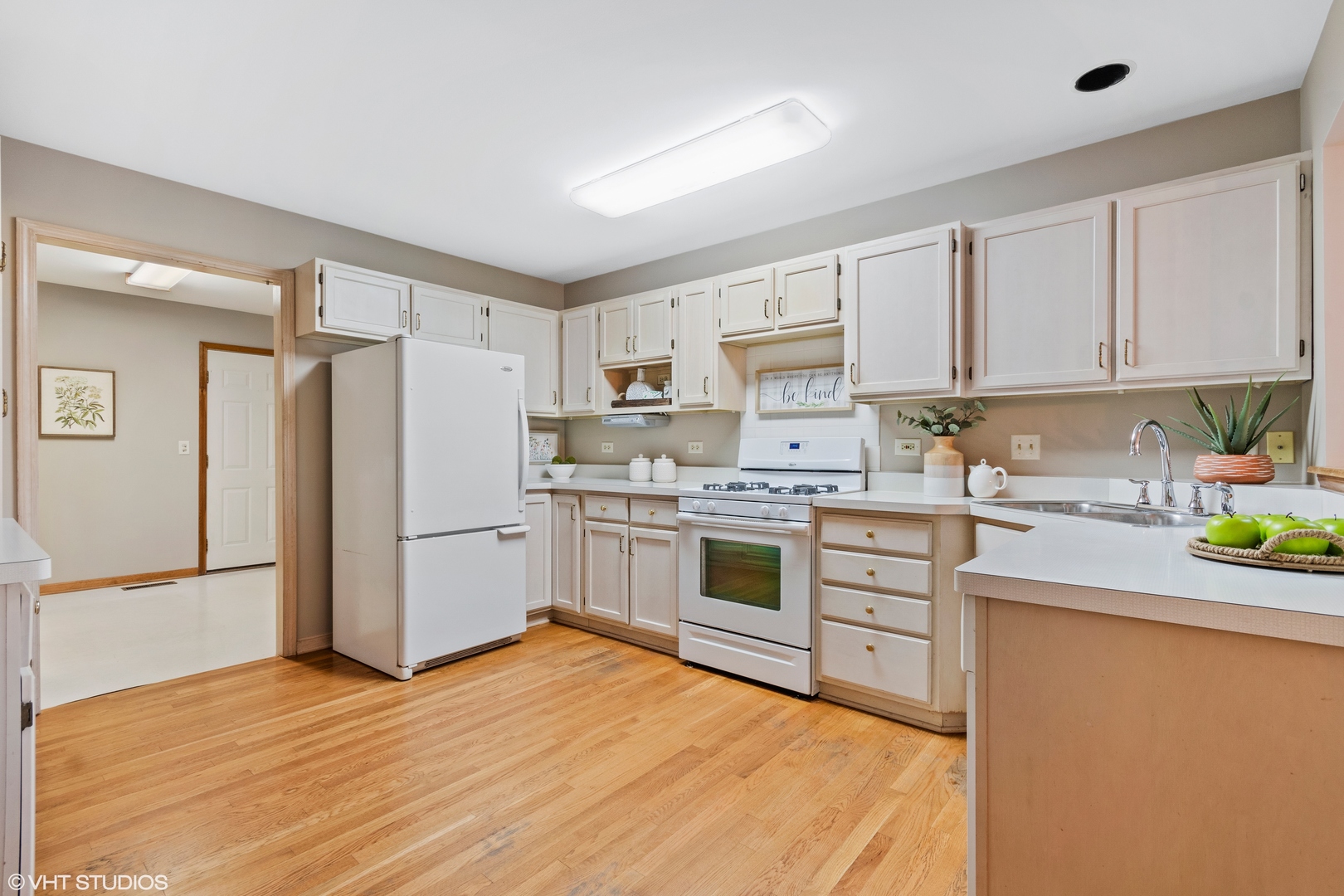 714 Natwill Square Geneva, IL 60134 - Photo 14 of 27 a kitchen with white cabinets and white appliances