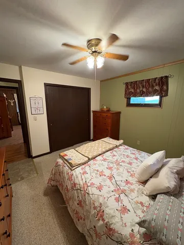 a bedroom with a bed and a flat tv screen