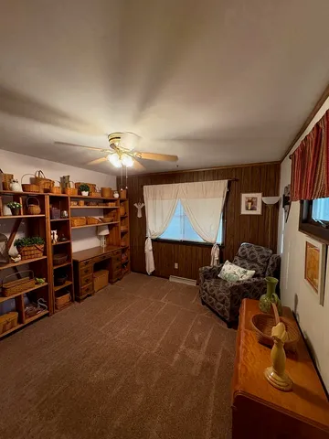 a view of a room with lots of wooden furniture