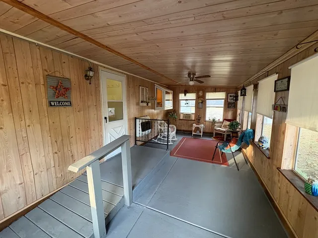 a view of a hall with furniture