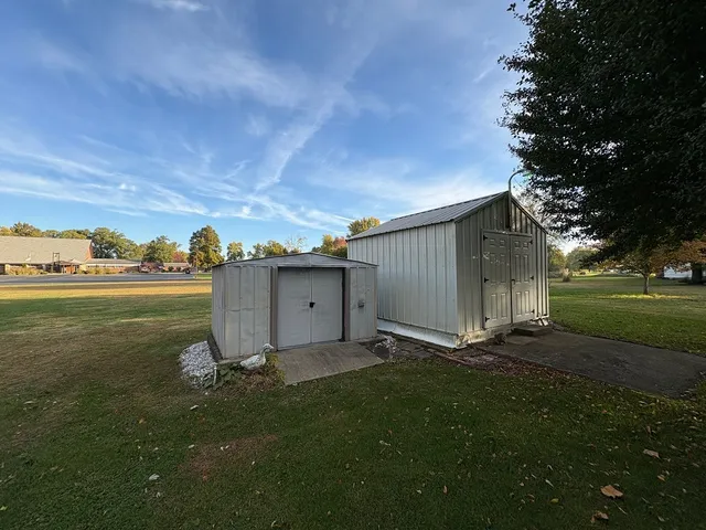 a view of a backyard with large trees