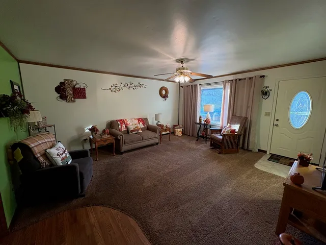 a living room with furniture a window and a flat screen tv