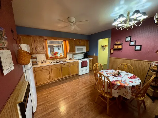 a kitchen that has a table chairs and wooden floor
