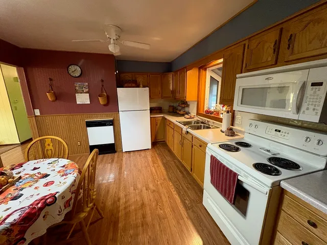 a kitchen with a stove a sink and a refrigerator